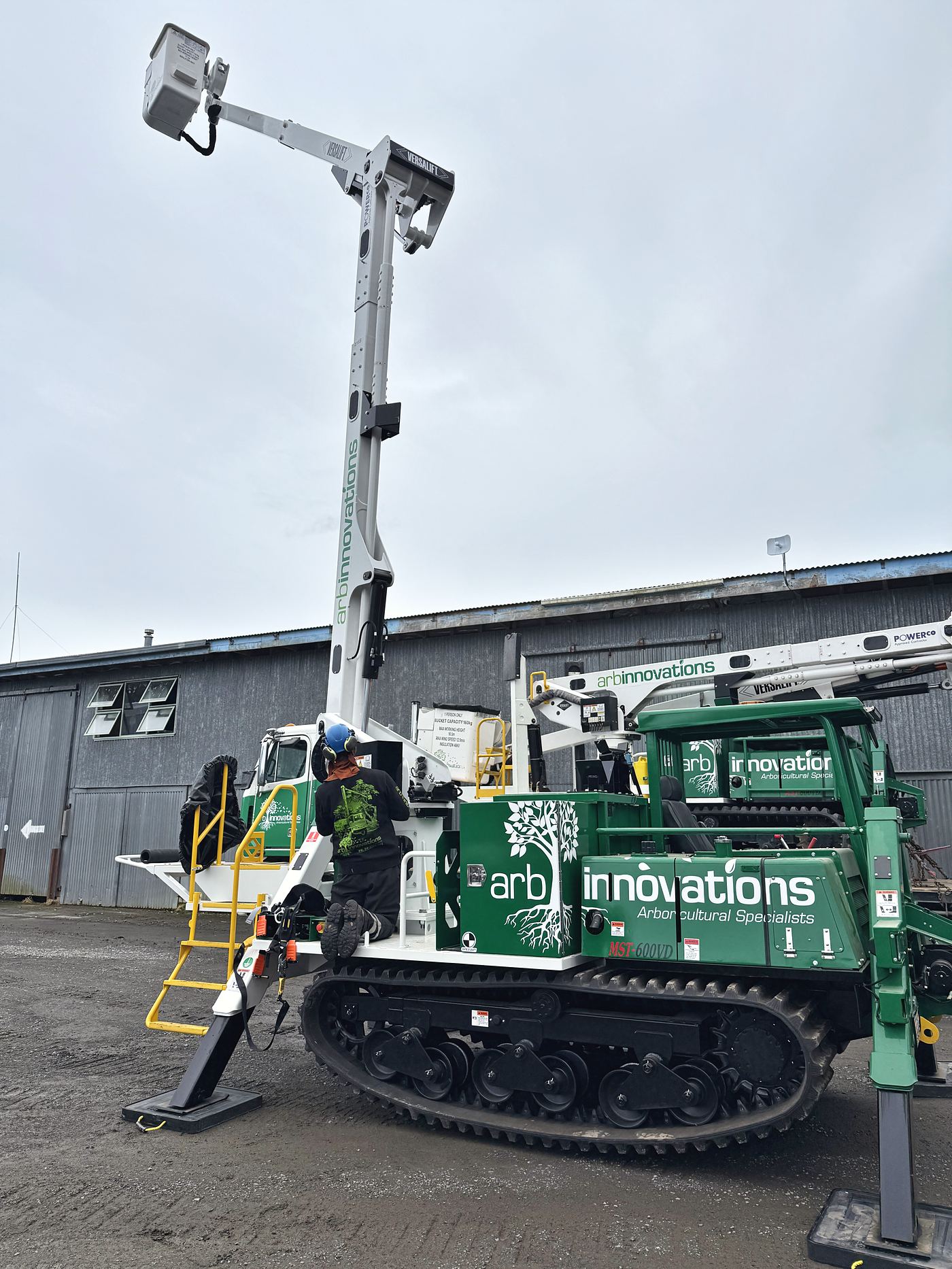 An Arb Innovations Marooka tracked elevated work platform with its insulated boom extended, in the yard