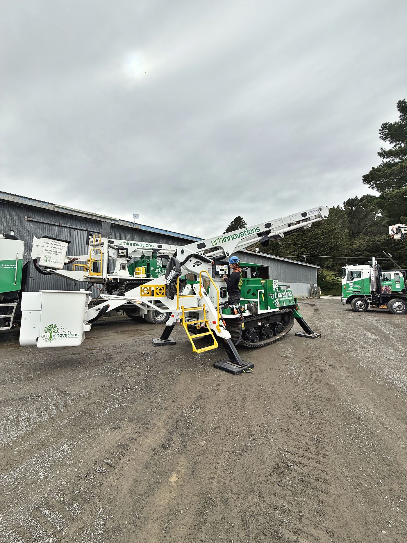 Two Arb Innovations Marooka tracked elevated work platforms alongside the line trucks at the yard