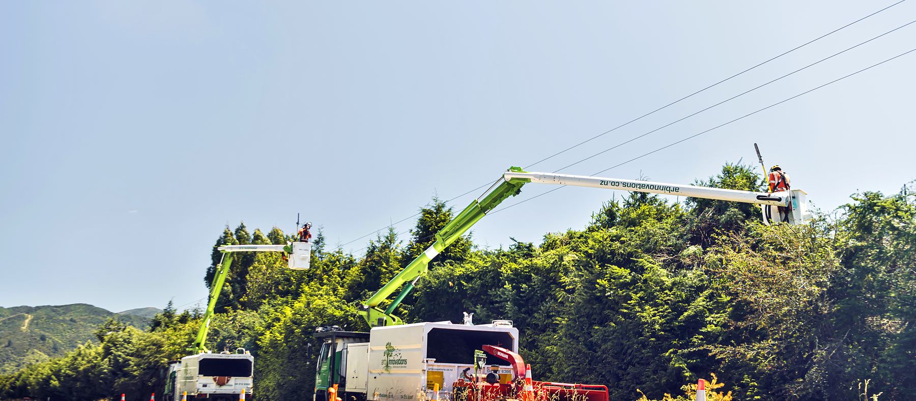 Arb Innovations elevated work platforms, truck and traffic cones working a rural roadside power line corridor